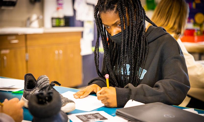 Students sketch shoes during art class